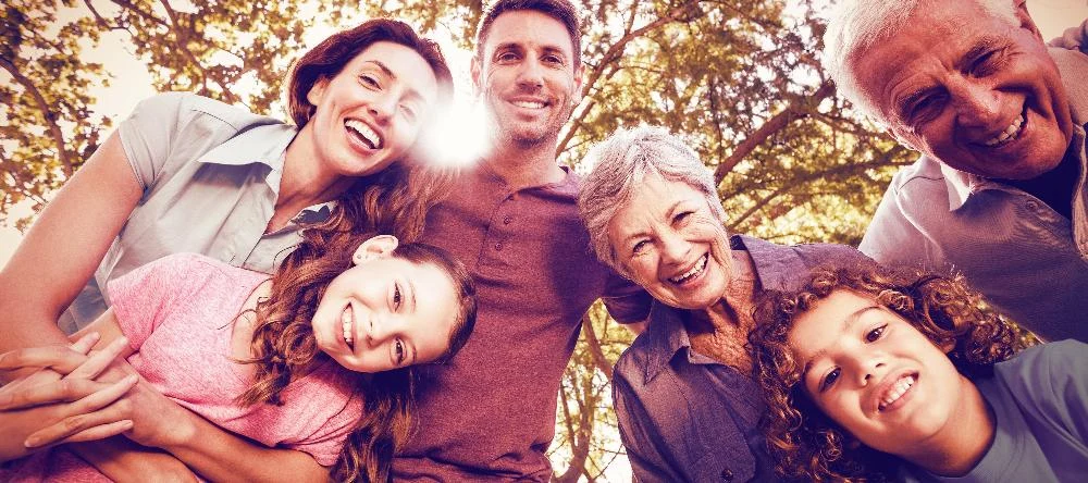 Smiling multi-generation family outdoors