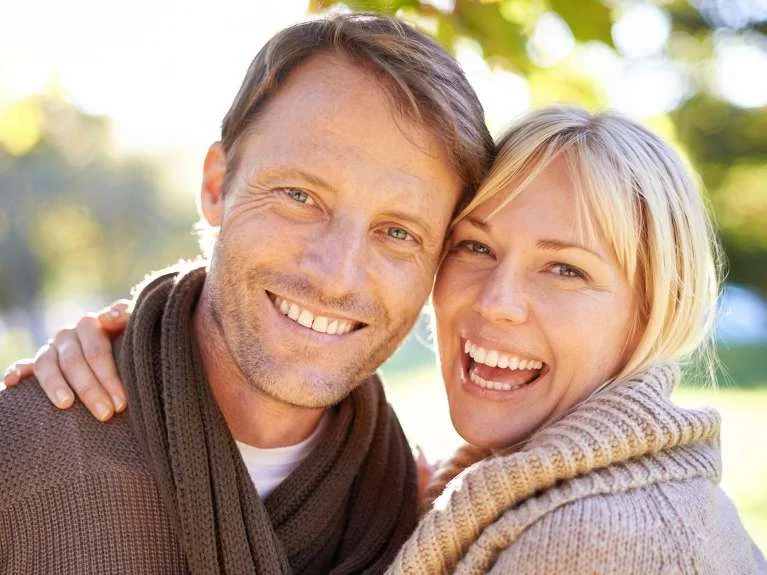 Smiling couple embracing outdoors